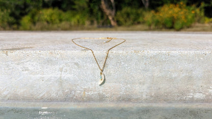 Dainty, gold stainless steel necklace with a cowrie shell pendant and tiny gemstones (personalizable and waterproof).