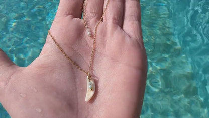 Dainty, gold stainless steel necklace with a cowrie shell pendant and tiny gemstones (personalizable and waterproof).